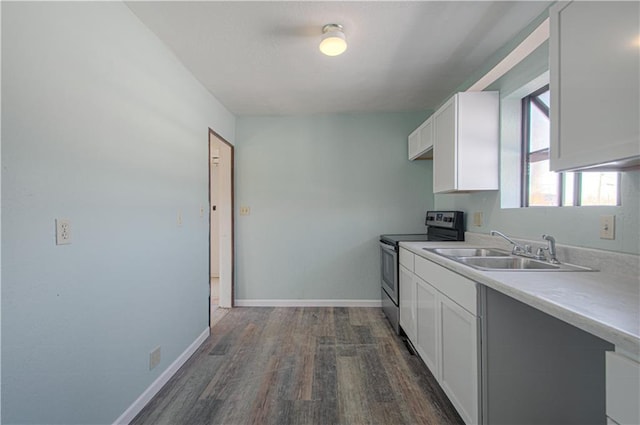 924 N Park Ave, Independence, MO 64050 - kitchen featuring stainless steel range with electric stovetop, dark wood-style flooring, white cabinetry, and light countertops