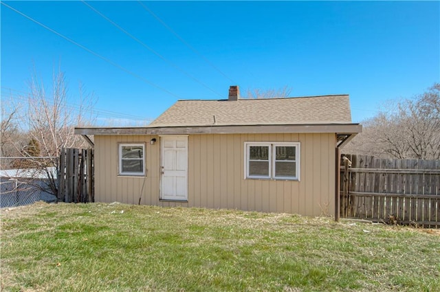 924 N Park Ave, Independence, MO 64050 - rear view of property featuring a fenced backyard, a shingled roof, and a chimney