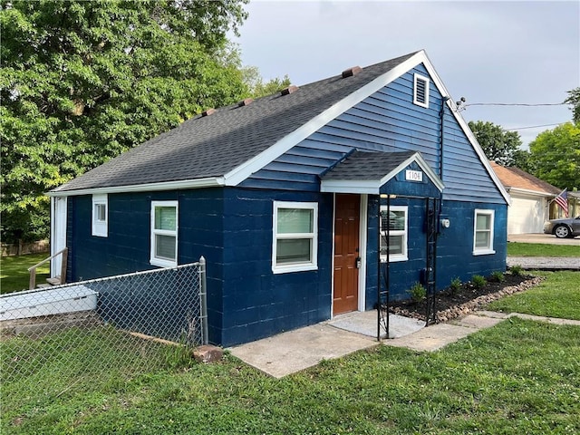 7104 N Cherry St, Gladstone, MO 64118 - view of front of house featuring a shingled roof and concrete block siding