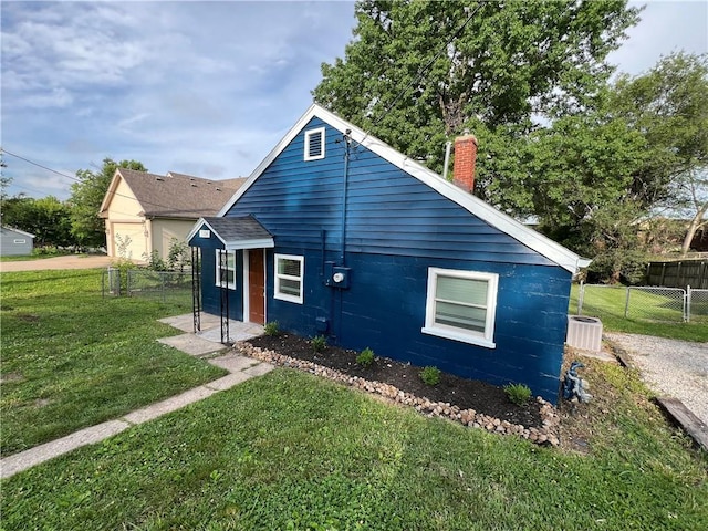 7104 N Cherry St, Gladstone, MO 64118 - rear view of property with a chimney
