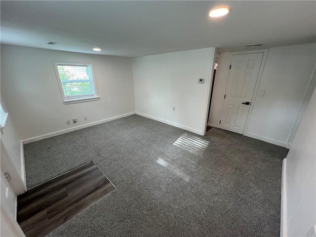 7104 N Cherry St, Gladstone, MO 64118 - spare room with dark colored carpet and recessed lighting