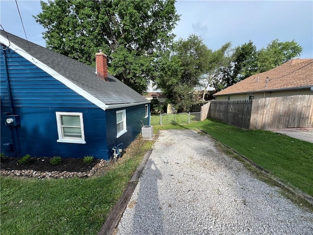 7104 N Cherry St, Gladstone, MO 64118 - view of home's exterior featuring a chimney and roof with shingles