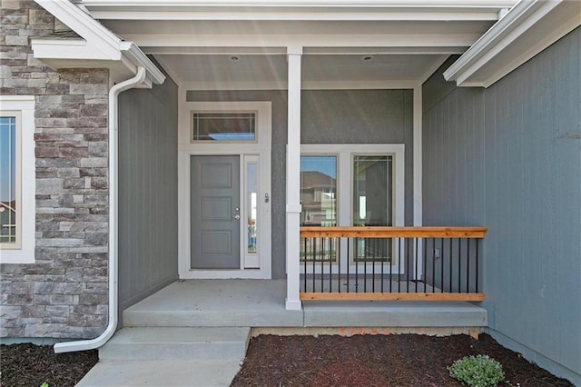 3707 NE 90th St, Kansas City, MO 64156 - doorway to property with stone siding and covered porch
