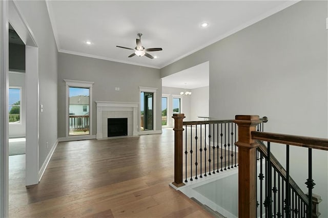 3707 NE 90th St, Kansas City, MO 64156 - hallway with wood finished floors, a chandelier, an upstairs landing, recessed lighting, and crown molding