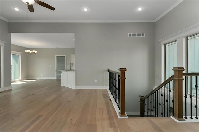 3707 NE 90th St, Kansas City, MO 64156 - empty room with light wood-style flooring, a chandelier, a ceiling fan, crown molding, and recessed lighting