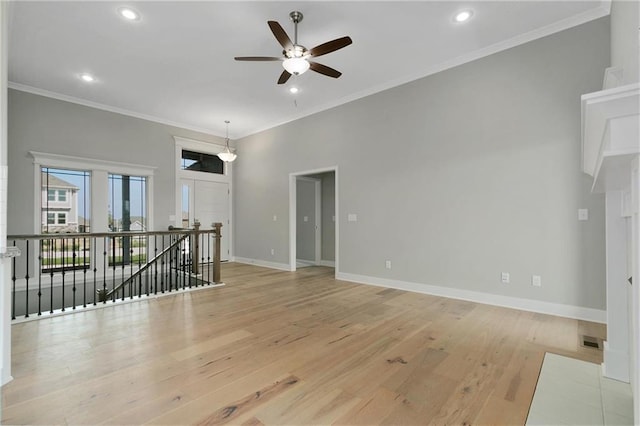 3707 NE 90th St, Kansas City, MO 64156 - unfurnished living room with a ceiling fan, recessed lighting, ornamental molding, and light wood-type flooring
