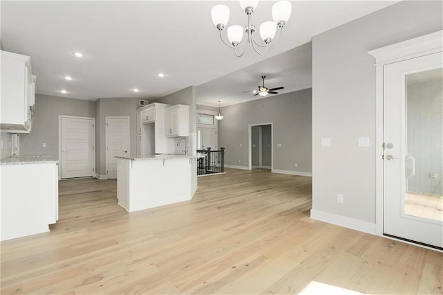 3707 NE 90th St, Kansas City, MO 64156 - kitchen featuring white cabinets, open floor plan, light wood-type flooring, a chandelier, and ceiling fan