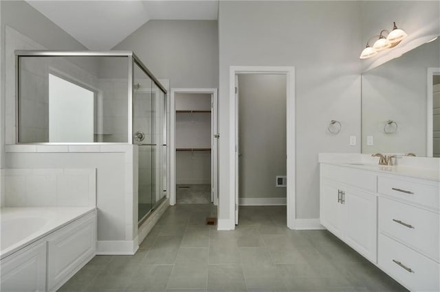 3707 NE 90th St, Kansas City, MO 64156 - full bathroom with a stall shower, a garden tub, vanity, tile patterned floors, and a spacious closet