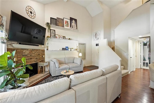 11134 Nieman Rd Unit 201, Overland Park, KS 66210 - living room featuring wood finished floors, stairway, a fireplace, and high vaulted ceiling