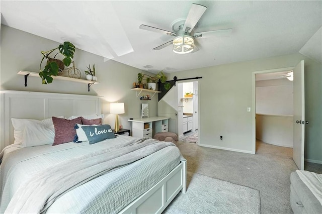11134 Nieman Rd Unit 201, Overland Park, KS 66210 - bedroom featuring light carpet, a barn door, ceiling fan, lofted ceiling, and ensuite bath