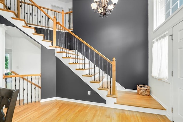 22833 W 44th St, Shawnee, KS 66226 - foyer entrance featuring wood finished floors, a high ceiling, and a chandelier