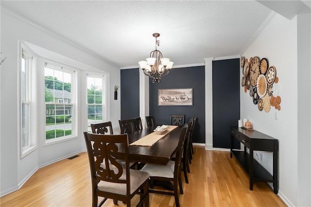 22833 W 44th St, Shawnee, KS 66226 - dining area featuring ornamental molding, light wood-type flooring, and a chandelier