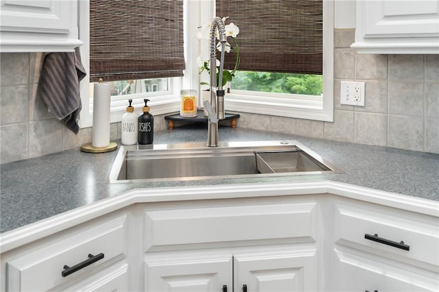 22833 W 44th St, Shawnee, KS 66226 - kitchen view of tasteful backsplash, white cabinetry, and light countertops