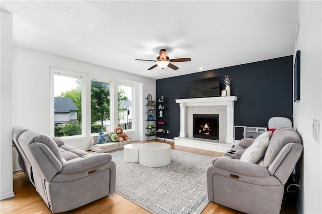 22833 W 44th St, Shawnee, KS 66226 - living room with ceiling fan, light wood finished floors, and a tiled fireplace