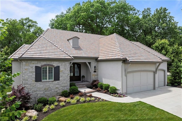 2189 W 89th Pl, Leawood, KS 66206 - view of front of property featuring stone siding, driveway, an attached garage, stucco siding, and a front lawn