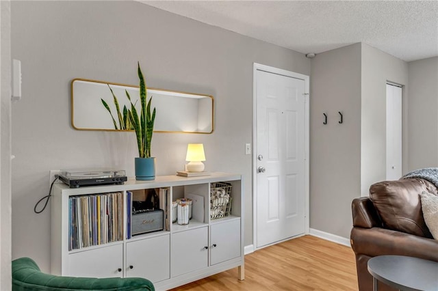 1509 W 25th Ct Unit A2, Lawrence, KS 66046 - sitting room featuring light wood finished floors and a textured ceiling