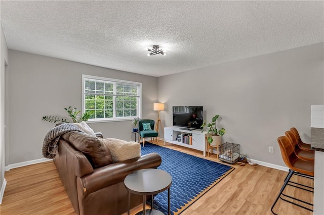 1509 W 25th Ct Unit A2, Lawrence, KS 66046 - living area with wood finished floors and a textured ceiling