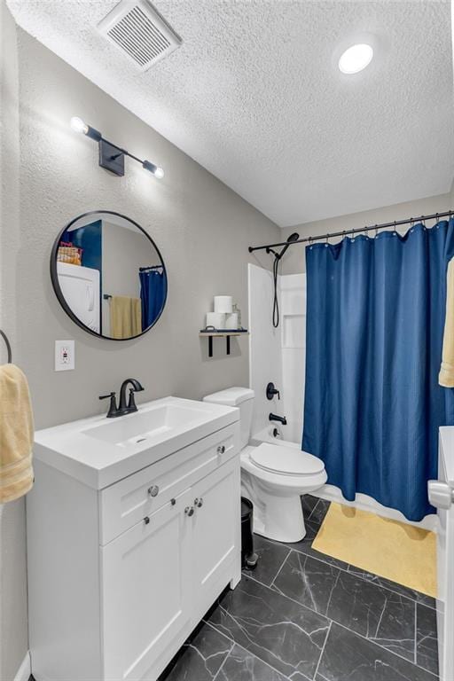 1509 W 25th Ct Unit A2, Lawrence, KS 66046 - full bathroom with a textured ceiling, vanity, and marble look tiles