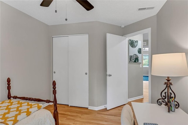 1509 W 25th Ct Unit A2, Lawrence, KS 66046 - bedroom featuring wood finished floors, a closet, and a ceiling fan