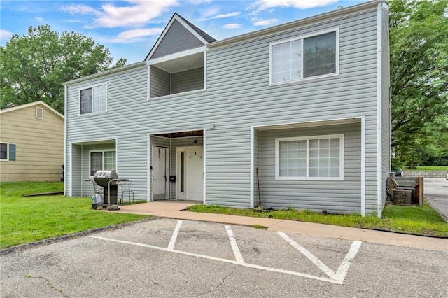1509 W 25th Ct Unit A2, Lawrence, KS 66046 - townhome / multi-family property with uncovered parking and a front lawn