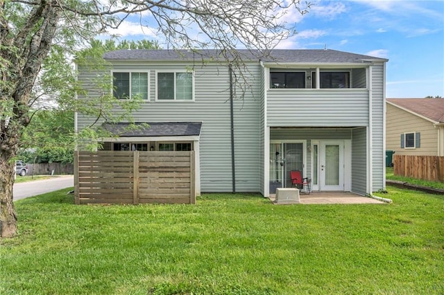 1509 W 25th Ct Unit A2, Lawrence, KS 66046 - rear view of property with a patio and roof with shingles