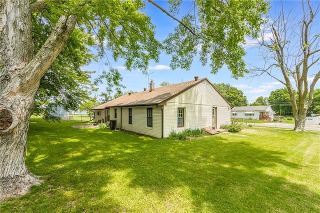 7306 N Holmes Ave, Gladstone, MO 64118 - view of property exterior featuring a lawn and a chimney
