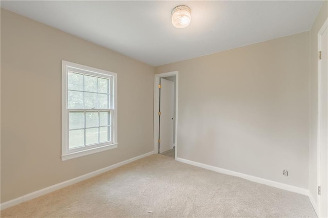 7306 N Holmes Ave, Gladstone, MO 64118 - unfurnished room featuring light colored carpet