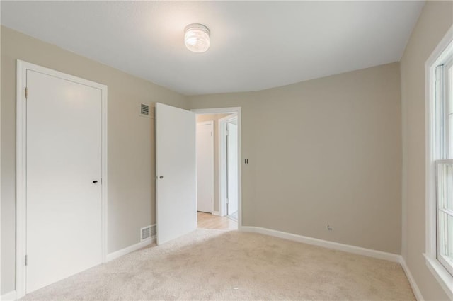 7306 N Holmes Ave, Gladstone, MO 64118 - unfurnished bedroom with light colored carpet