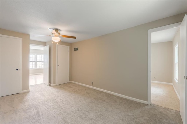 7306 N Holmes Ave, Gladstone, MO 64118 - spare room featuring light colored carpet and ceiling fan