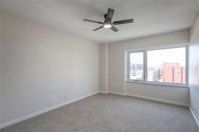4545 Wornall Rd Unit 1009, Kansas City, MO 64111 - empty room featuring ceiling fan, carpet, and a textured ceiling
