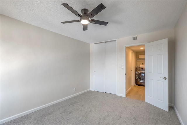 4545 Wornall Rd Unit 1009, Kansas City, MO 64111 - unfurnished bedroom with washer / clothes dryer, a textured ceiling, carpet floors, a closet, and ceiling fan