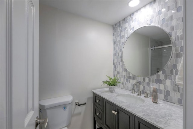4545 Wornall Rd Unit 1009, Kansas City, MO 64111 - bathroom featuring decorative backsplash, vanity, and a shower