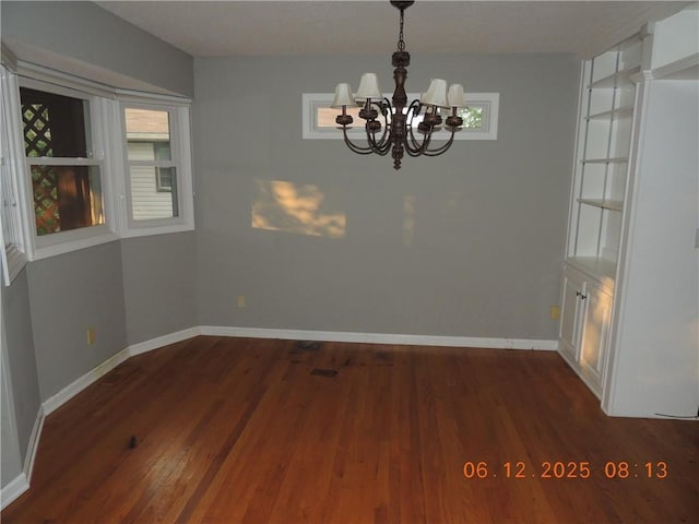 326 Virginia Rd, Excelsior Springs, MO 64024 - unfurnished dining area featuring a chandelier, dark wood finished floors, and healthy amount of natural light