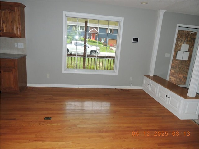326 Virginia Rd, Excelsior Springs, MO 64024 - unfurnished dining area featuring light wood-style flooring and baseboards