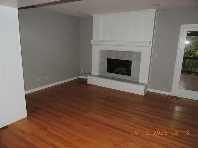 326 Virginia Rd, Excelsior Springs, MO 64024 - unfurnished living room with wood finished floors and a high end fireplace
