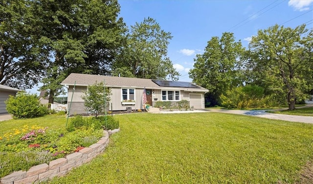13500 Spring St, Grandview, MO 64030 - view of front facade with driveway, roof mounted solar panels, a garage, and a front lawn