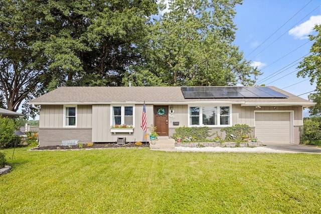 13500 Spring St, Grandview, MO 64030 - single story home with an attached garage, solar panels, a front yard, and board and batten siding