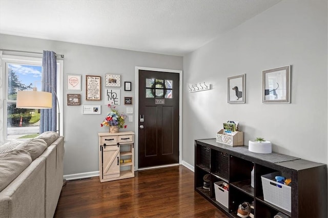13500 Spring St, Grandview, MO 64030 - foyer featuring dark wood-style floors and baseboards