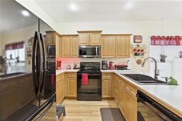 22802 W 72nd Ter, Shawnee, KS 66227 - kitchen with black appliances, light countertops, decorative backsplash, light wood-style flooring, and crown molding