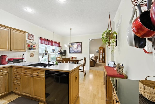 22802 W 72nd Ter, Shawnee, KS 66227 - kitchen with black dishwasher, ornamental molding, light countertops, light wood finished floors, and a textured ceiling