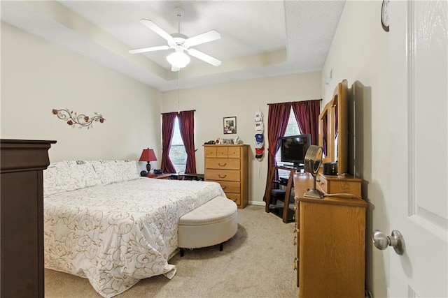 22802 W 72nd Ter, Shawnee, KS 66227 - bedroom featuring light colored carpet, multiple windows, a raised ceiling, and ceiling fan