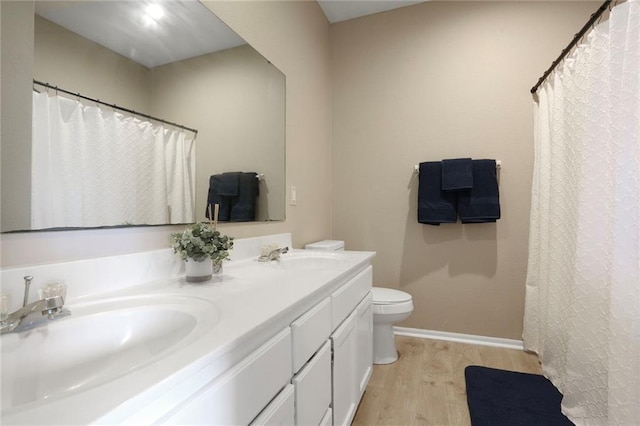 653 S Woodson Ln, Gardner, KS 66030 - bathroom featuring wood finished floors, double vanity, and curtained shower