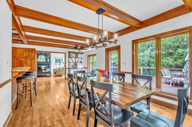 22810 SW Hampton Ct, Blue Springs, MO 64015 - dining space featuring beam ceiling, light wood-style flooring, and a chandelier