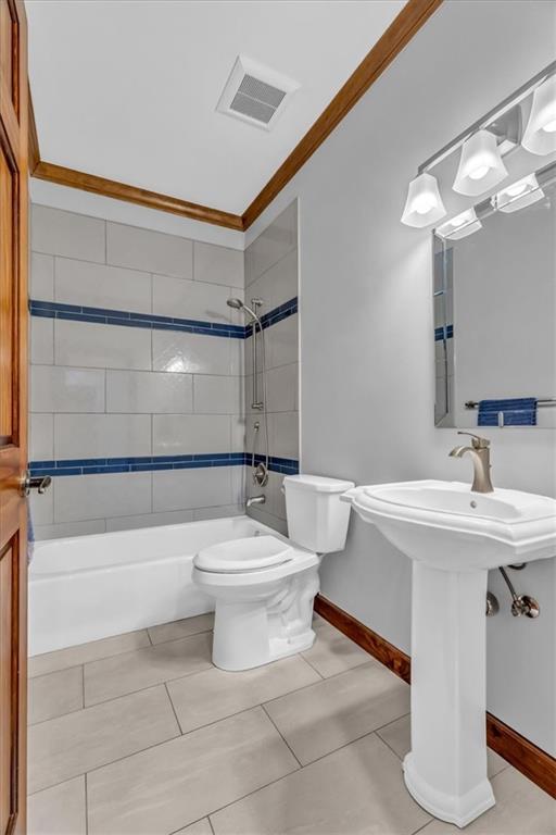 22810 SW Hampton Ct, Blue Springs, MO 64015 - bathroom featuring tile patterned flooring, shower / bathtub combination, and ornamental molding