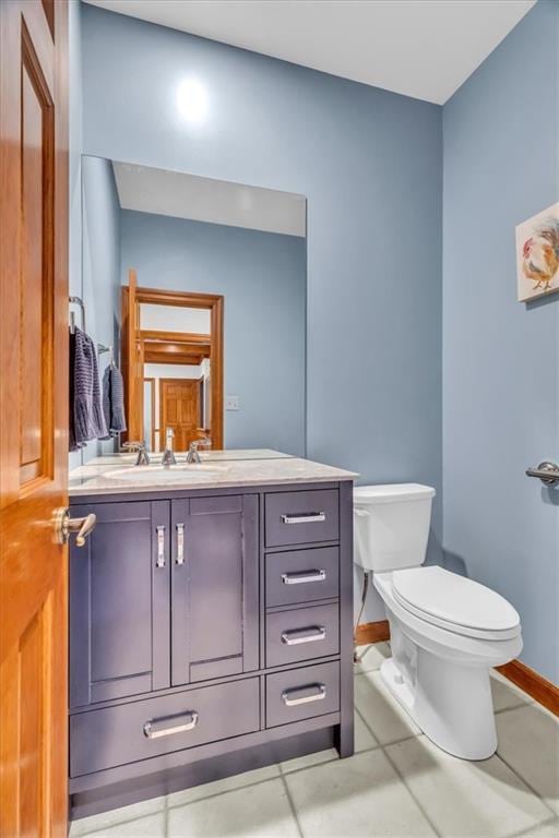 22810 SW Hampton Ct, Blue Springs, MO 64015 - half bathroom featuring vanity and tile patterned floors
