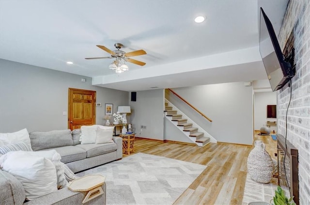 22810 SW Hampton Ct, Blue Springs, MO 64015 - living area with a brick fireplace, stairs, wood finished floors, ceiling fan, and recessed lighting