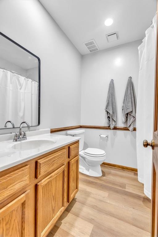 22810 SW Hampton Ct, Blue Springs, MO 64015 - bathroom with vanity and wood finished floors