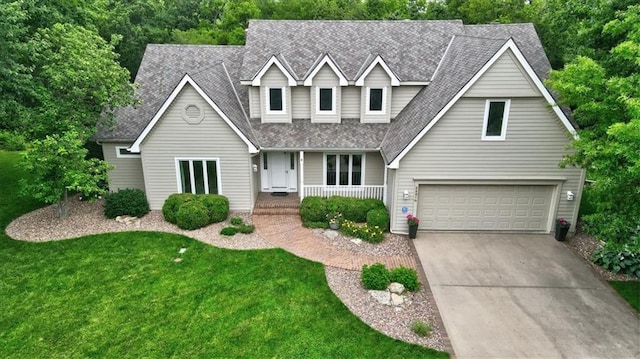 22810 SW Hampton Ct, Blue Springs, MO 64015 - traditional-style home with covered porch, an attached garage, a shingled roof, concrete driveway, and a front yard