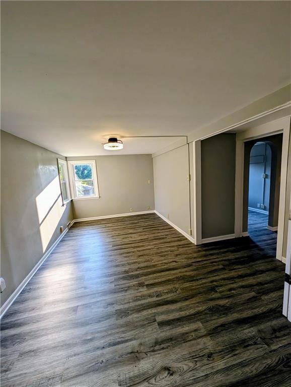 830 Locust St, Eudora, KS 66025 - unfurnished room with dark wood-style floors and arched walkways