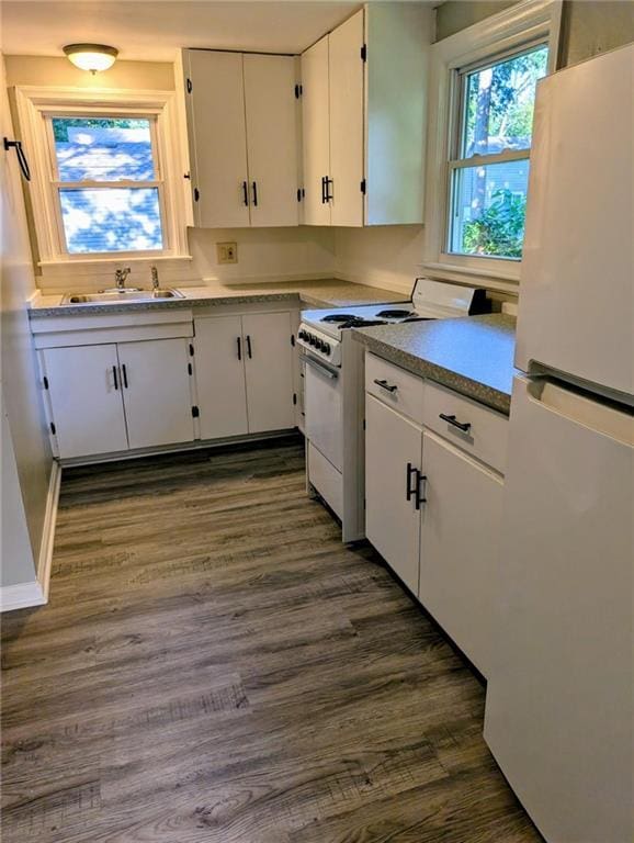 830 Locust St, Eudora, KS 66025 - kitchen featuring white appliances, white cabinetry, and dark wood-style floors